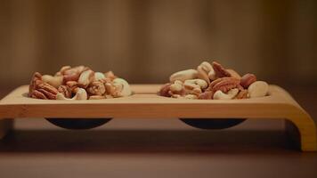 Mixed Nuts of Almonds Pecan Walnuts Cashews Hazelnuts on Wooden Table video