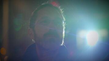 Young Man with Glasses Watching Light Show in the City at Night video