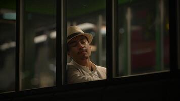 Young Man Waiting Alone at Train Station Platform at Night video