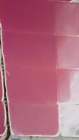 Aerial view of pink salt lake. Salt production facilities in saline evaporation ponds. Red and pink water due to Dunaliella salina in a mineral lake. Vertical video