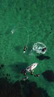 A man flies on a FlyBoard. Aerial top down view. Water extreme sport, azure summer sea with outdoors active people enjoying water sports. Flyboarding and seariding, Recreation and sports concepts. video