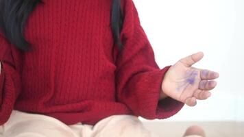 a kid clapping hands and smiling, sitting on sofa . video