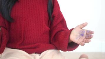 a kid clapping hands and smiling, sitting on sofa . video