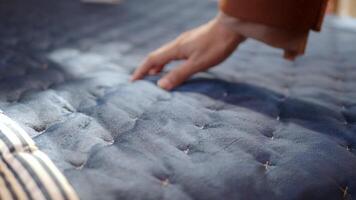 woman Hand touching and pressing orthopedic mattress on bed. video