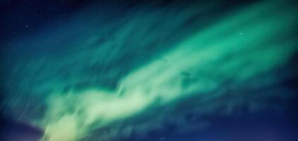 Beautiful Aurora borealis and starry glowing in the night sky on arctic circle photo