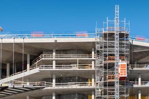 Worker working on structure of scaffolding photo