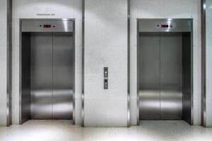 Metallic elevator two gate closed of passenger lift photo