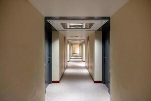 Empty corridor with closed rows door with lighting decoration photo