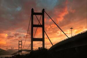 Large suspension bridge cross the sea with colorful sky in the sunset photo