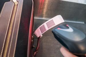 Laser scanner barcode reader scanning for loading luggage bag photo