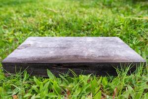 Empty wooden board on grass photo