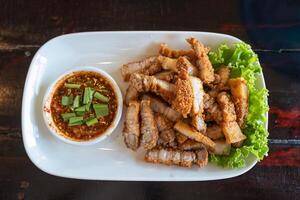 Fried pork belly with fish sauce and spicy dipping sauce photo