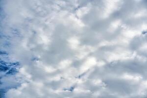 White cloudy forming on blue sky in sunny day photo