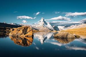 Matterhorn mountain reflected on Lake Stellisee in the morning at Zermatt, Switzerland photo