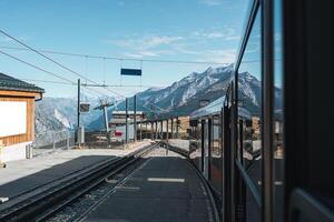 View from train running to station among Swiss Alps at Switzerland photo