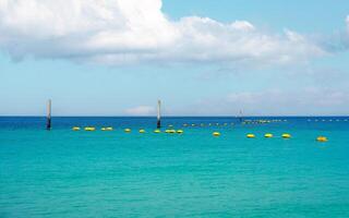 Tropical turquoise sea with safety area buoy floating and pillar photo