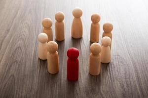 Wooden people figures on top of wooden blocks. Career growth, development and leadership photo