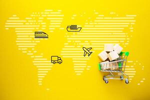 Trolleys with boxes of goods on yellow background. The concept of logistics and delivery of goods. photo