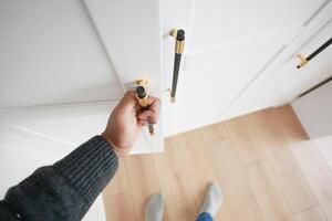 hand opening bedroom cabinet door photo