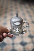 hand hohlding a cup of turkish coffee photo