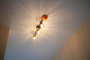 A light fixture is suspended from the ceiling, illuminating the room photo