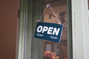 Open sign hanging front of cafe . photo