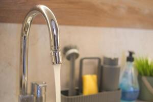 water pouring from a faucet tap slow motion photo