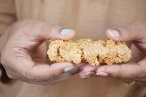 women holding a oat protein bar photo