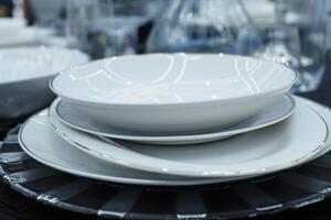 round bowl or ceramic plate on napkin on wooden table. photo