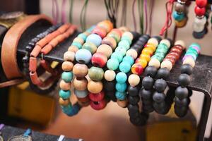 Bracelets with beads, laid out in the street market in the sun. photo