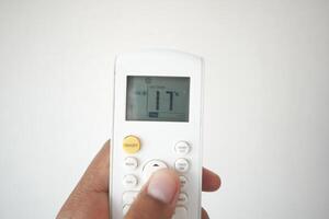 Close up of man hand holding air condition remote. photo