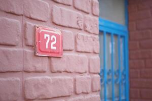 house number. Decorative lettering on a brick wall. photo