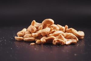 cashew nuts on black color background photo