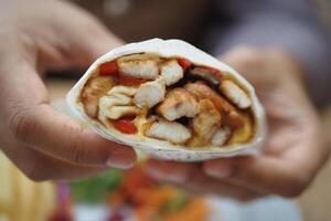 woman hand eating chicken warp photo