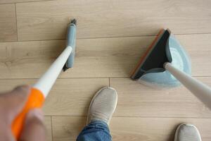 top view of men suing floor dust with dust pan photo