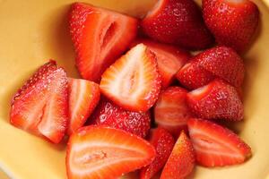 Ripe Red Strawberries in a bowl on table photo
