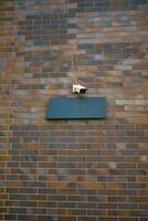 CCTV security camera operating on a wall photo