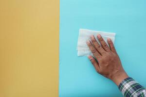 person hand cleaning table with cloth photo