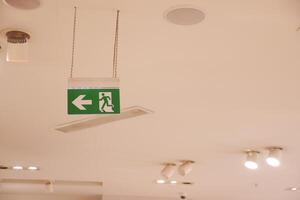 Fire exit sign at the corridor in building photo