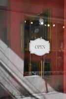 open text on paper hanging on cafe door photo