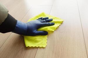 A man's hand washing the floor with a cloth photo