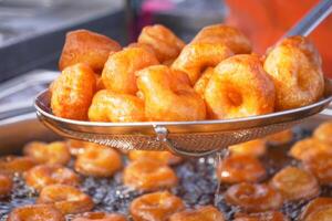 Traditional fried sweets lokma in sugar syrup photo