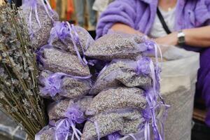 A stack of purple lavender bags fills the basket, creating a beautiful pattern photo