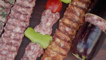 A tray of kebabs with meat and veggies a delicious dish on the table video