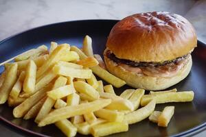 junk foods on plate on wooden table close up photo