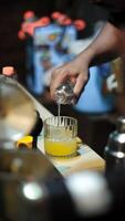 Pouring orange syrup at the restaurant bar. photo