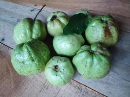 Freshly picked crystal guava isolated on wooden background photo