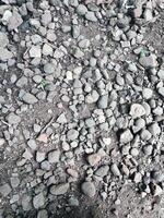 Smooth round pebbles texture background. Pebble sea beach close up, dark wet pebbles and gray dry pebbles photo