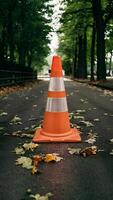 AI generated view Traffic cone on sidewalk surrounded by leaves, safety concept photo Vertical Mobile Wallpaper