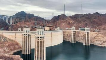 Engineering Marvel at Hoover Dam, Hoover Dam, renowned for its monumental concrete arch-gravity structure, is captured here with the Mike O'Callaghan Pat Tillman Memorial Bridge in the background video